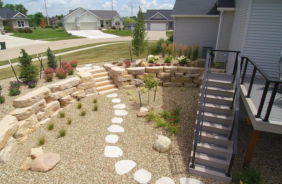 Aerial view of concrete block retaining walls with drainage and paver patio